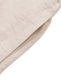Close-up of beige fabric texture on a white background