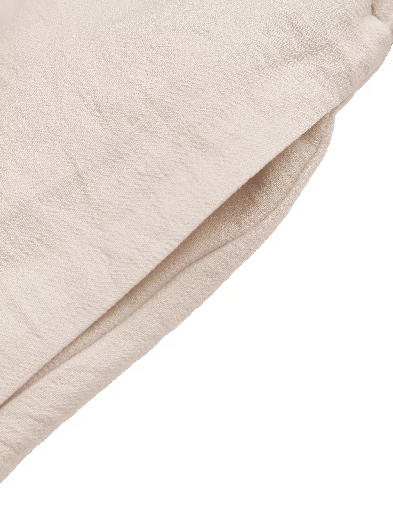 Close-up of beige fabric texture on a white background