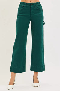 Green wide-leg pants worn by a person on a white background