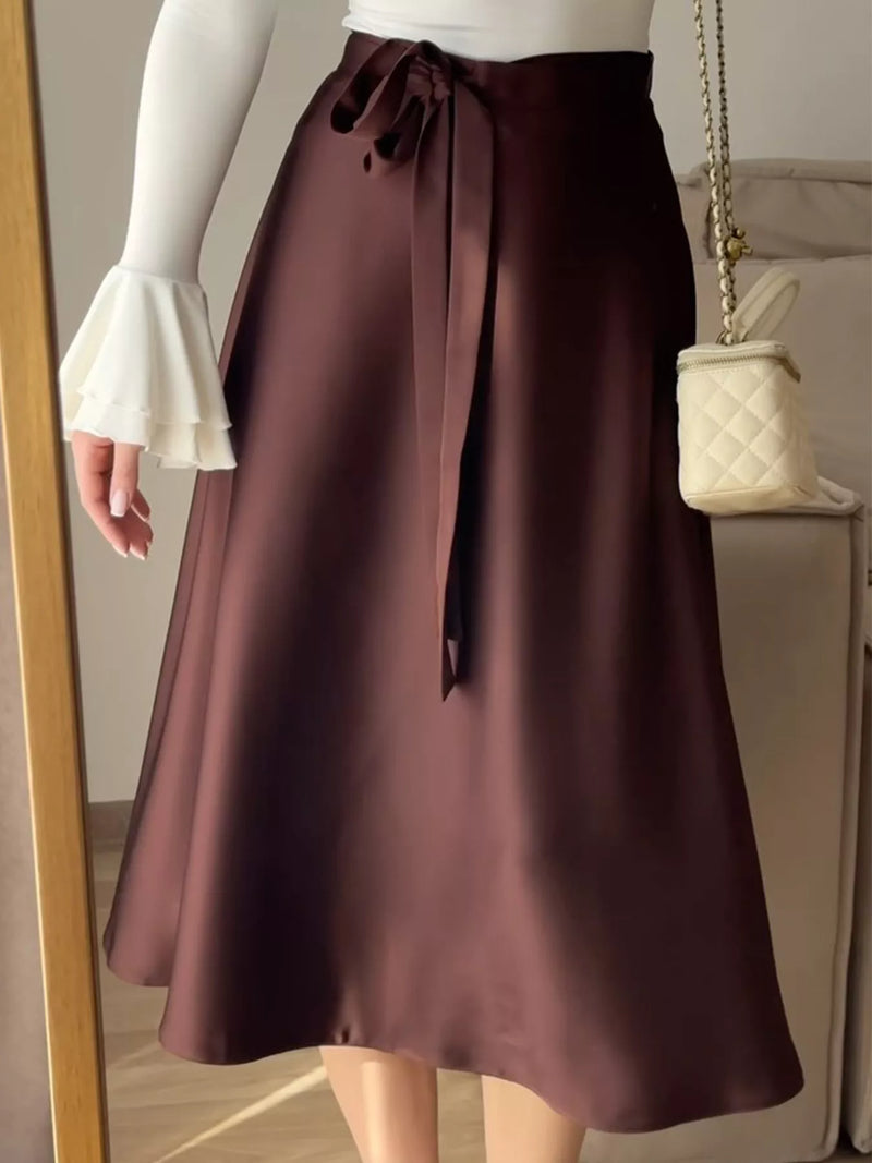 Brown skirt worn by a person with a neutral background