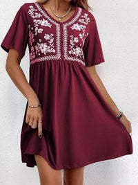 Maroon dress with white floral embroidery on a white background