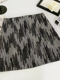 Black and white patterned rug on a white floor