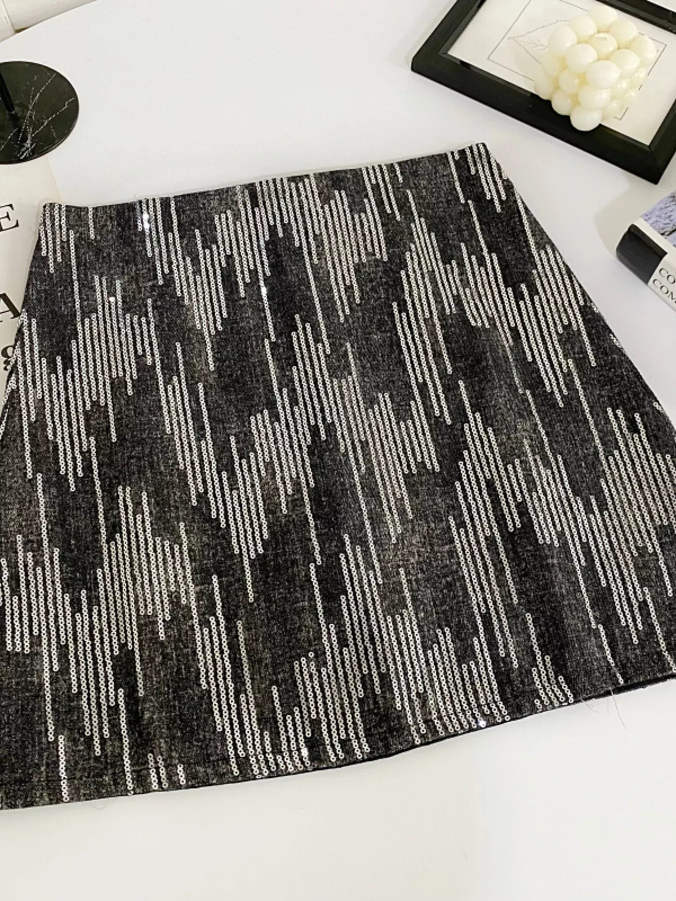 Black and white patterned rug on a white floor