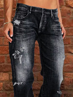 Person wearing distressed black jeans against a brick wall.