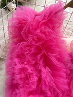 Close-up of a bright pink tulle skirt with a blurred background