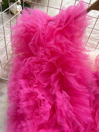 Close-up of a bright pink tulle skirt with a blurred background