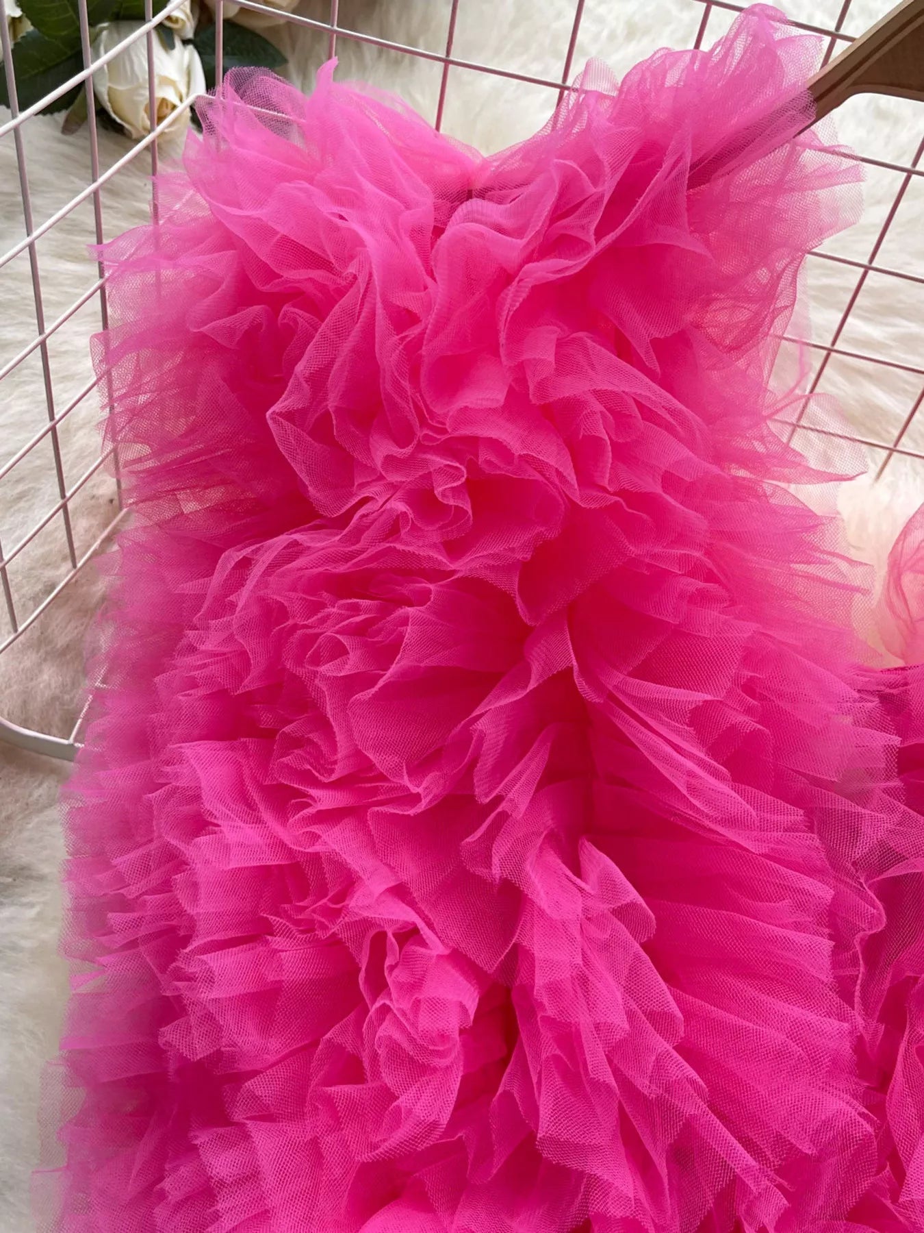 Close-up of a bright pink tulle skirt with a blurred background