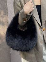 Gray coat with a navy blue fur collar against a neutral background