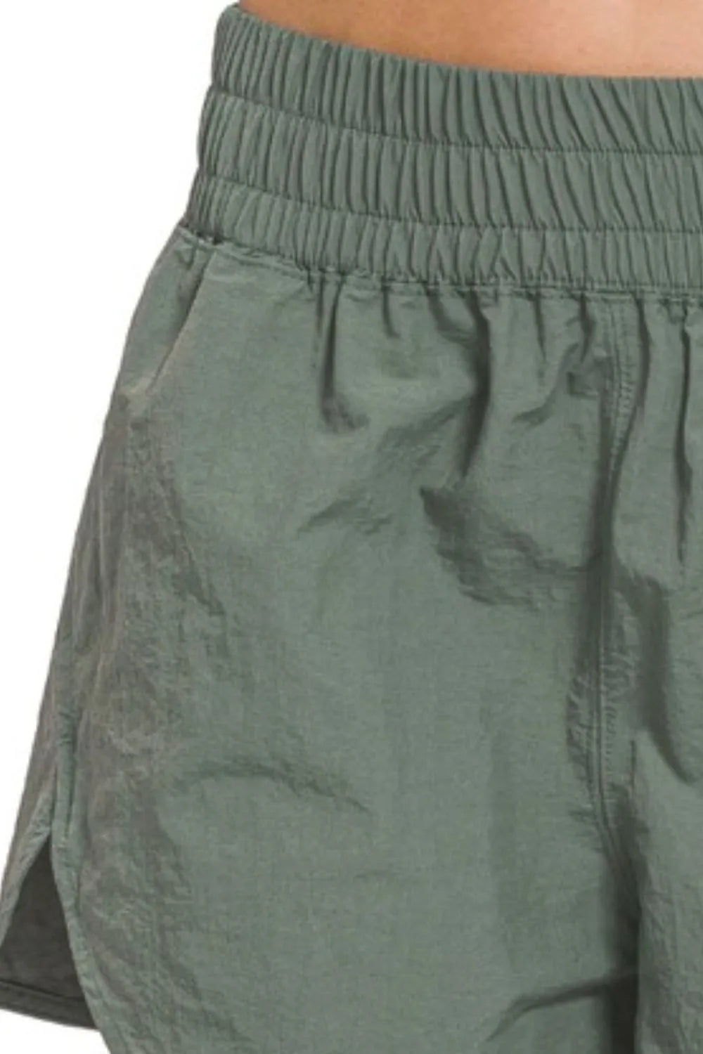 Close-up of green shorts with a white background