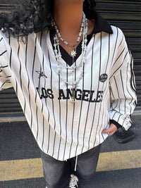 Person wearing a 'Los Angeles' striped shirt with a blurred face.