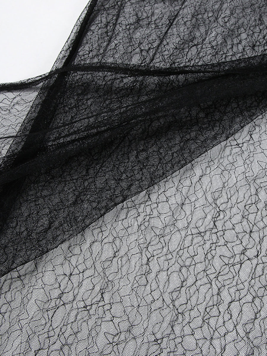 Close-up of black lace fabric on a white background