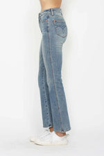 Light blue jeans worn by a person on a white background