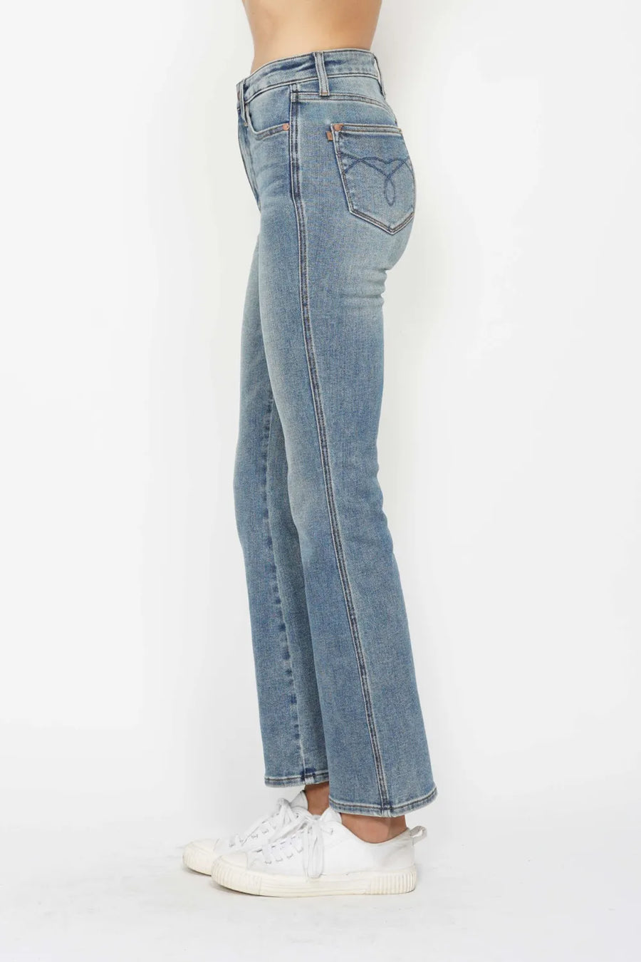 Light blue jeans worn by a person on a white background