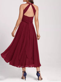 Burgundy halter neck dress with open back on a white background