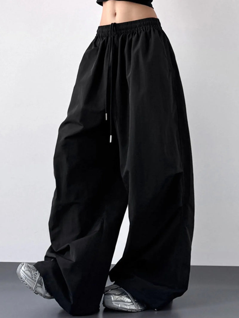Black wide-leg pants worn by a person on a plain background