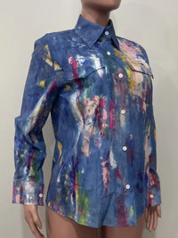 Mannequin wearing a colorful abstract patterned shirt against a plain background