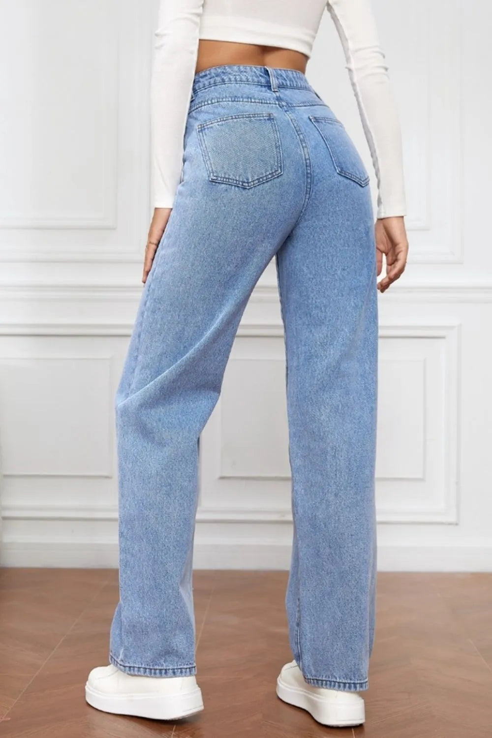 Light blue jeans worn by a person on a white background