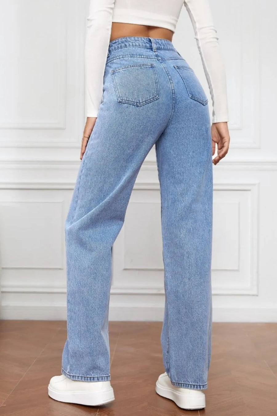 Light blue jeans worn by a person on a white background
