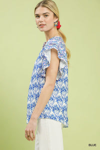Woman wearing a blue and white patterned top on a light green background