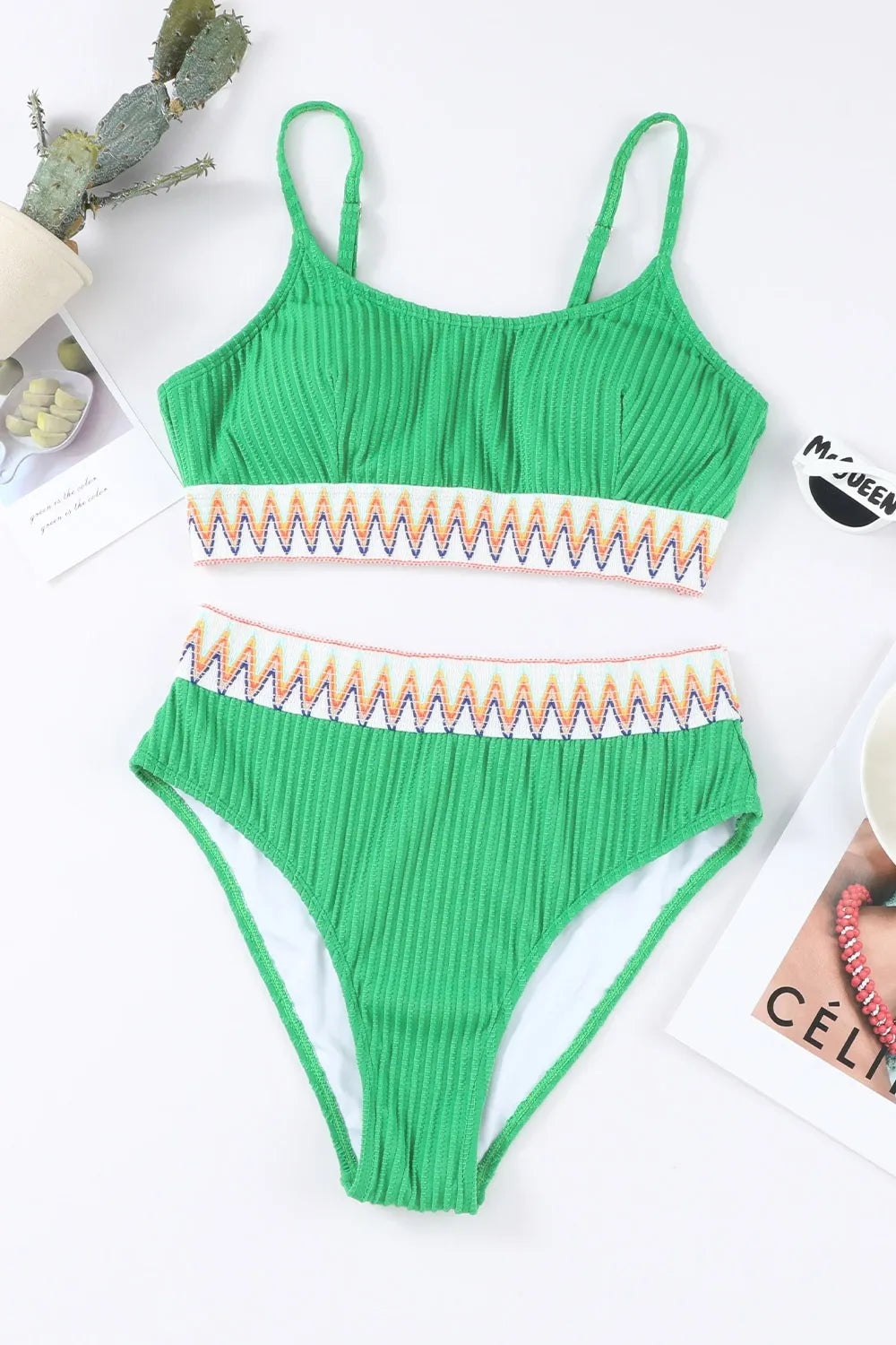 Green bikini set with striped details on a white background
