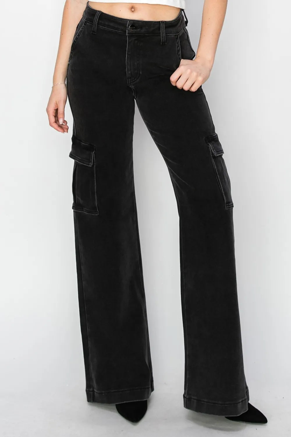 Black cargo pants worn by a person on a white background