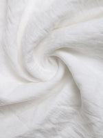Close-up of white fabric with folds