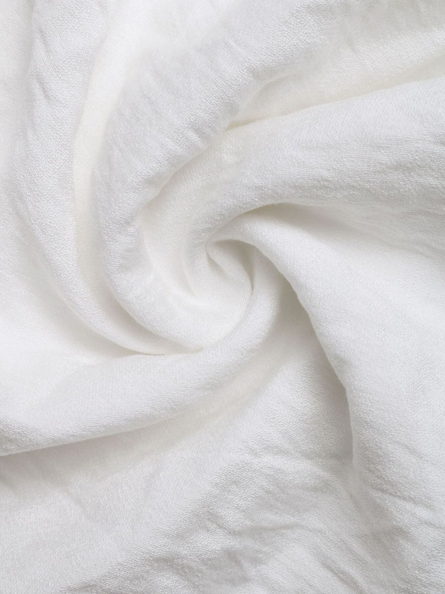Close-up of white fabric with folds
