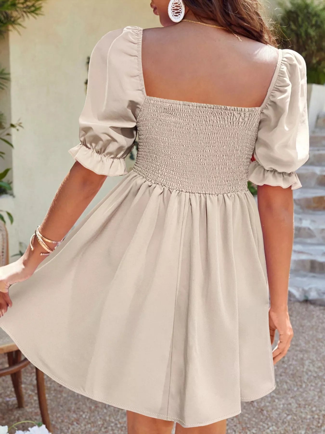 Beige dress with puff sleeves worn by a person, outdoor setting