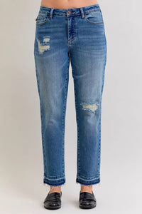 Blue jeans with distressing on a white background