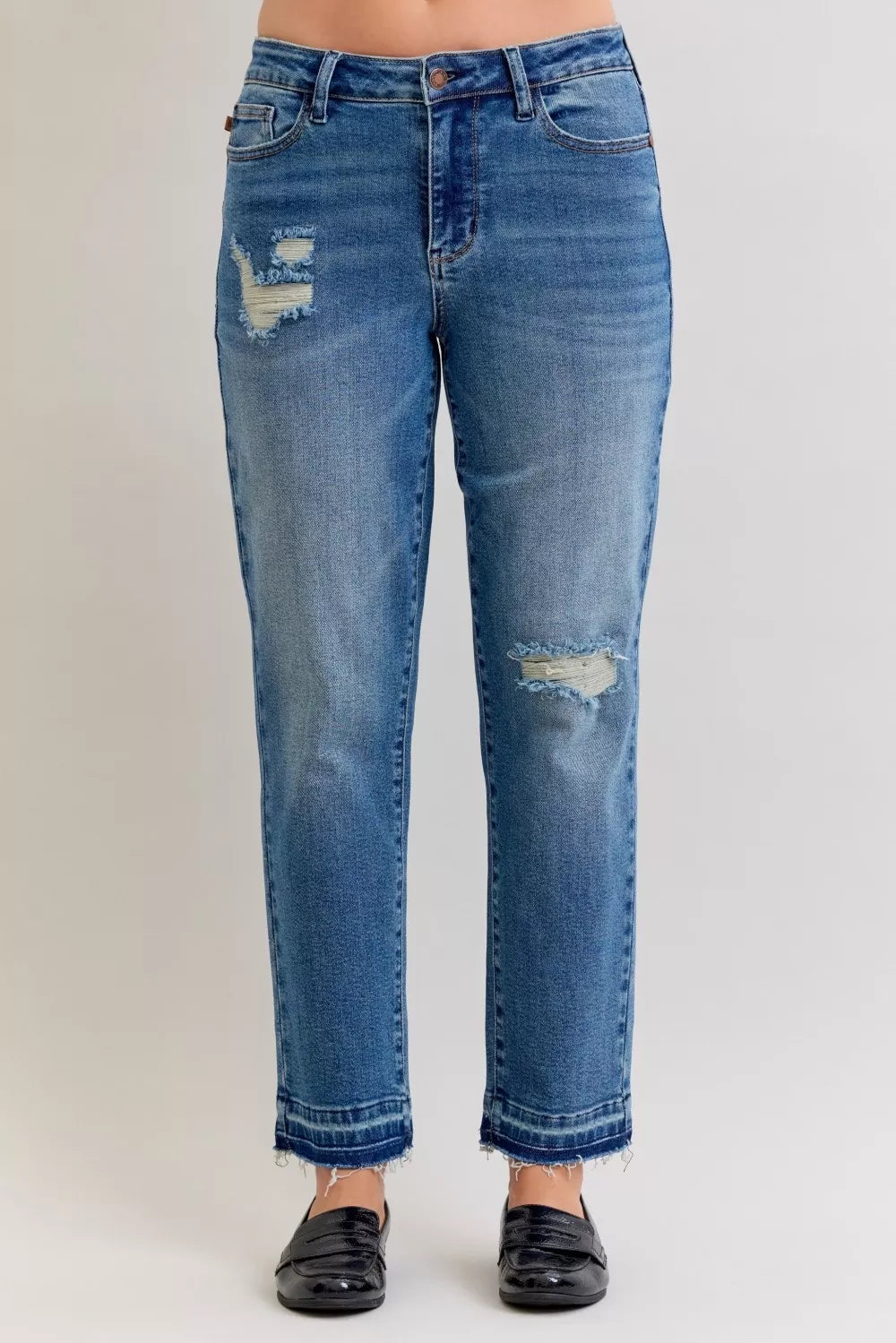Blue jeans with distressing on a white background