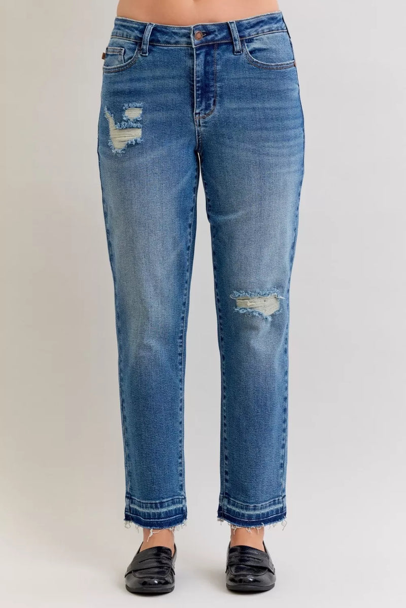Blue jeans with distressing on a white background
