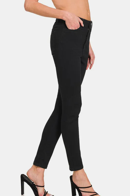 Black pants worn by a person on a white background