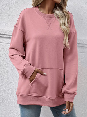Person wearing a pink sweatshirt with a plain background