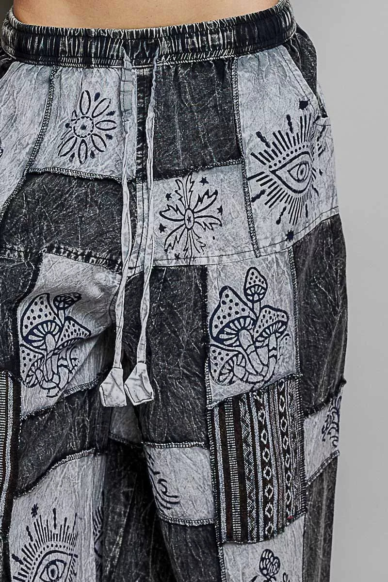 Patchwork pants with black and white patterns on a gray background