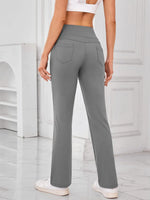 Person wearing gray pants in a minimalistic setting