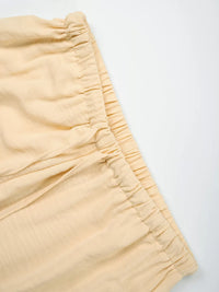 Close-up of beige shorts on a white background
