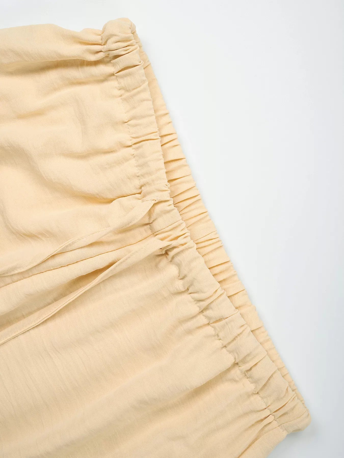 Close-up of beige shorts on a white background