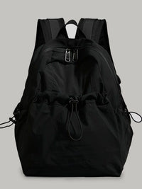 Black backpack on a light gray background