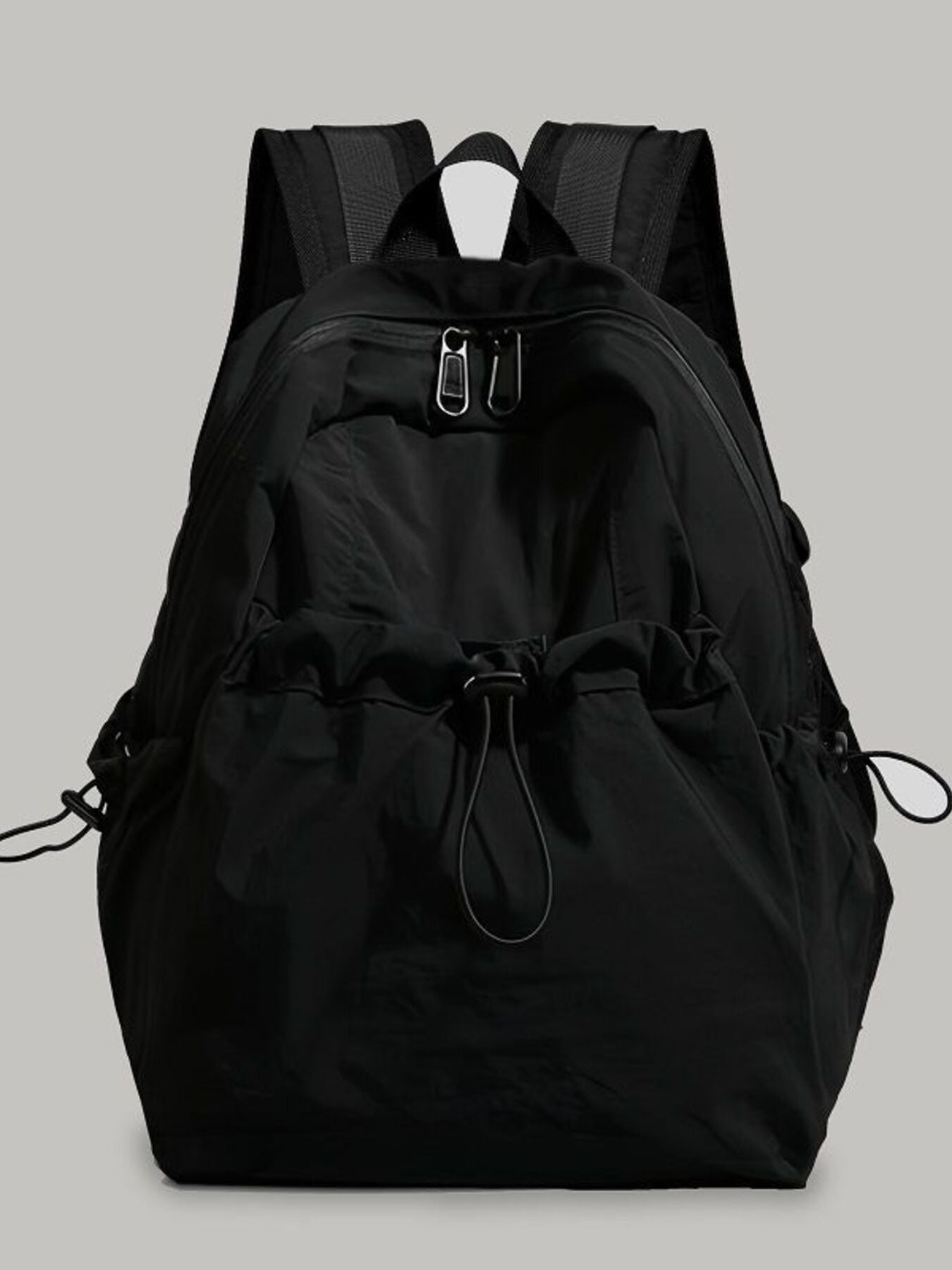 Black backpack on a light gray background