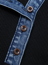 Close-up of a denim jacket with buttons on a black background