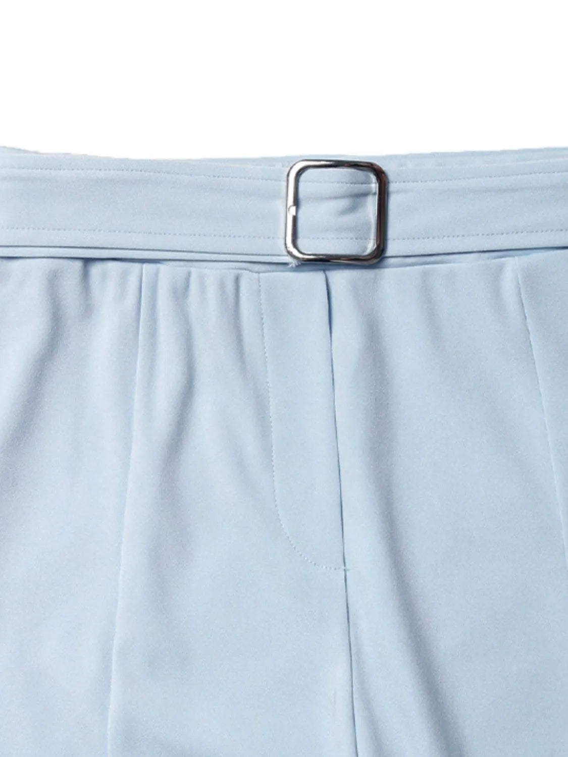 Light blue pants with a silver belt buckle on a white background