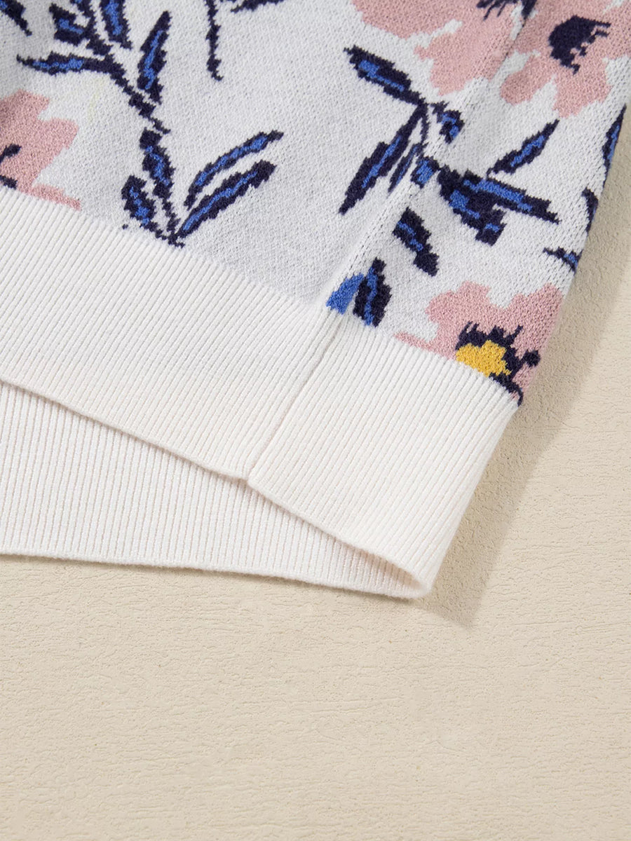 Close-up of a floral patterned fabric with pink and blue flowers on a beige background