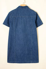 Blue denim dress on a hanger against a white background