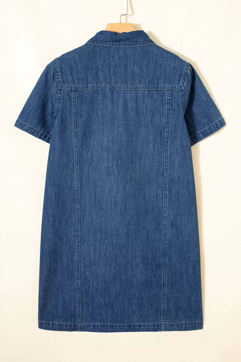 Blue denim dress on a hanger against a white background