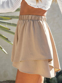 Beige skirt worn by a person with a blurred background