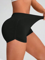 Black athletic shorts worn by a person on a light gray background