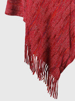 Red plaid blanket with fringe on a light gray background