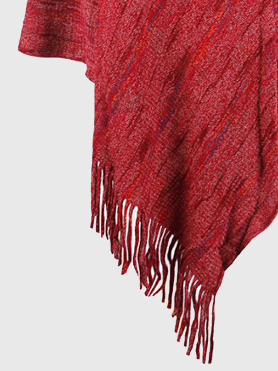 Red plaid blanket with fringe on a light gray background