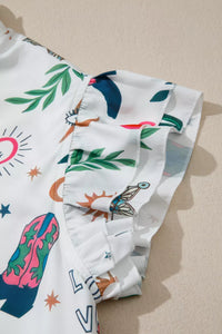 Folded fabric with colorful desert-themed design on a beige surface