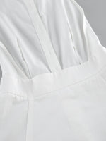 Close-up of a white garment with a focus on texture and folds.
